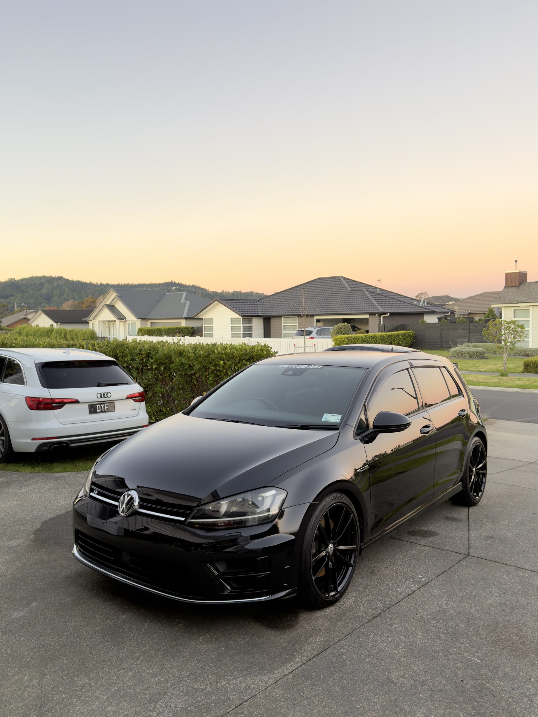 Black Volkswagen Golf on a driveway.