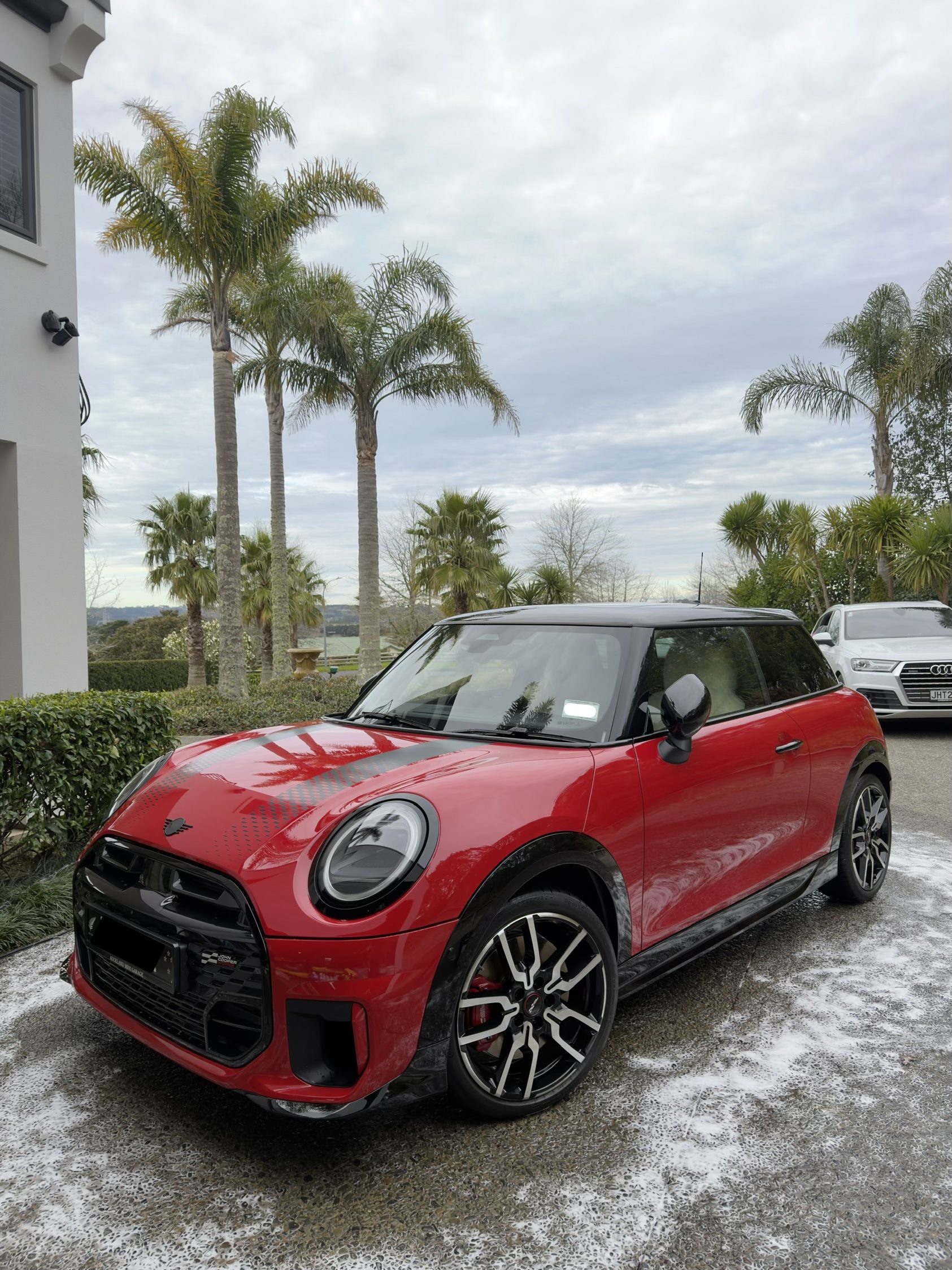 Red Mini on a driveway.
